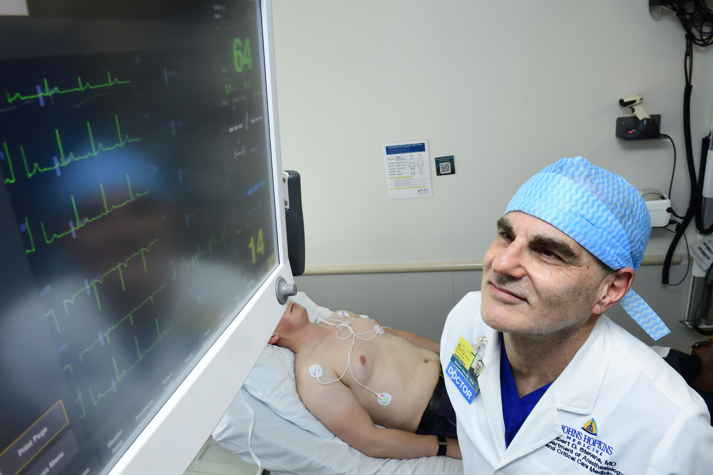 Dr Robert Stevens, chief of the Division of Informatics, Integration and Innovation at Johns Hopkins Medicine, observes an electrocardiogram monitor. Credit: Will Kirk/Johns Hopkins University